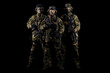 © andy_gin - Three soldiers in uniform with a weapon in their hands are looking menacingly.
