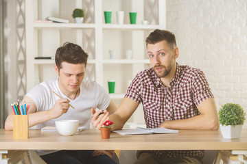 Poster - Attractive guys doing paperwork front