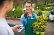 © pikselstock - Paying with credit card at garden center