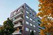 © Robert Herhold - brick apartment building framed by yellow tree