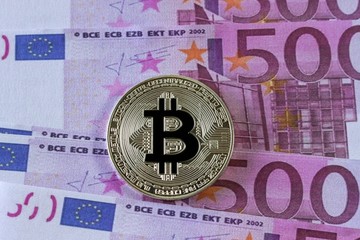 Silver Bitcoin on Euro banknote background