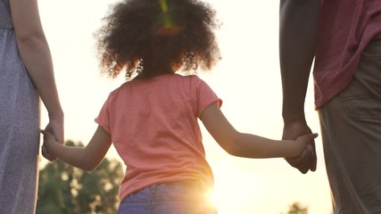 Wall Mural - Little girl holds fathers and mothers hands, happiness and wellbeing in family