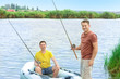 © Africa Studio - Two men fishing from inflatable boat on river