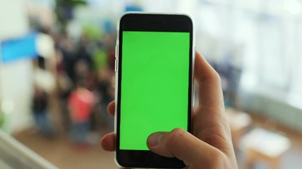 closeup man hand using black smart phone mobile green screen chromakey display typing tapping texting message sms chatting communication online login website app pointing text touchscreen wifi chat