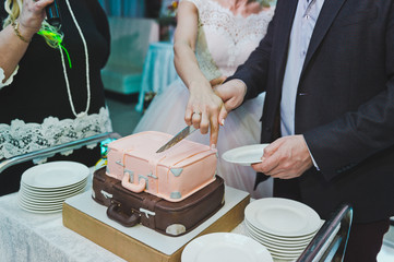 Wall Mural - The process of cutting a beautiful wedding cake 8585.