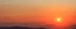 © Rawf8 - Beautiful sunset on sky over mountains background. The sun is on the right side.
