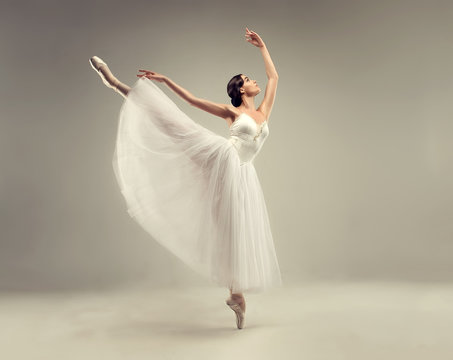 ballerina. young graceful woman ballet dancer, dressed in professional outfit, shoes and white weigh