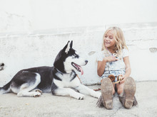Beautiful Blonde Girl Poses With Pet Siberian Husky