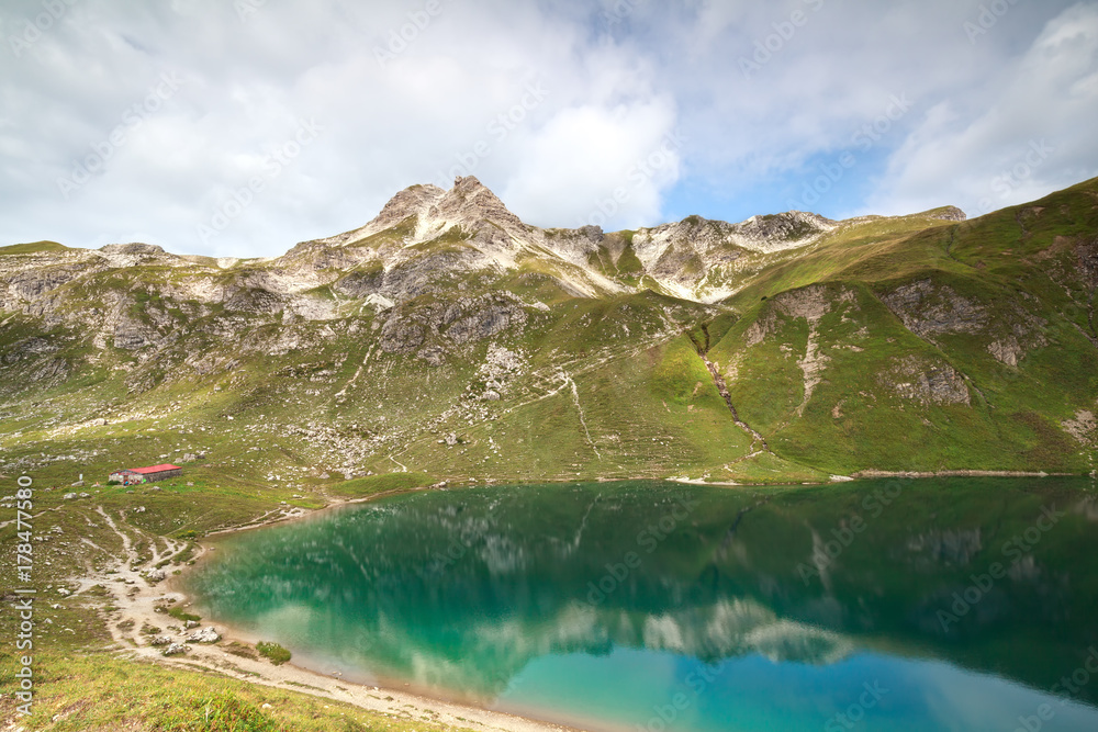 turquoise alpine lake in mountains - obrazy, fototapety, plakaty 