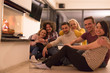 © .shock - multiethnic couples sitting in front of fireplace