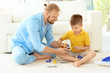 © Africa Studio - Father playing with cute son at home