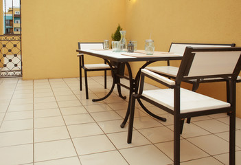 Wall Mural - Table and chairs on roof terrace