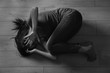 © Africa Studio - Battered young woman lying on floor