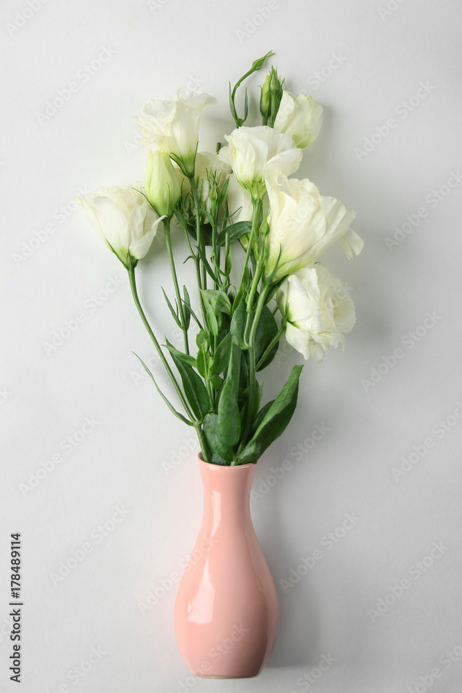 Vase with beautiful flowers on white background