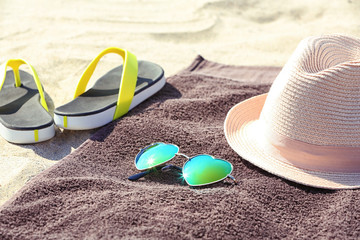 Canvas Print - Brown beach towel and summer accessories on sand