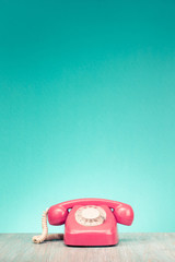 Fototapete - Retro aged telephone on wooden table front mint green wall background. Vintage old style filtered photo