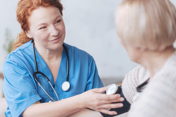 Wall Mural - Thoughtful medical worker measuring blood pressure