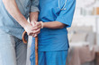 © zinkevych - Close up of female nurse helping elderly patient to walk