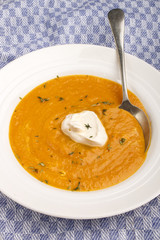 Wall Mural - carrot soup with sour cream and a deep plate