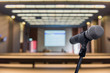 © nattanan - Microphone over the blurred forum Meeting Conference Training Learning or Coaching Room Concept, Blurred background