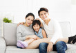 © Tom Wang - Happy asian family on sofa in living room
