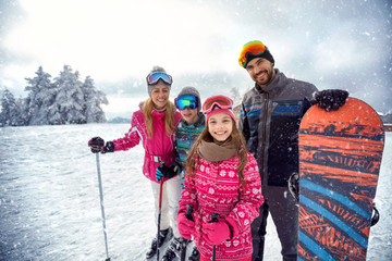 Wall Mural - family enjoying winter sports and vacation on snow in mountains