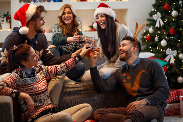 Wall Mural - Young people toasting in Christmas eve