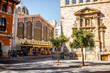 Street view with saint Joan church and famous food market Central in Valencia city, Spain