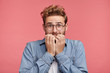 © wayhome.studio - Worried hipster guy bites nails, looks nervous before passing exam or important event in his life. Embarrassed fashionable young man being afraid of difficulties, stands against pink background