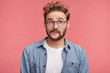 © wayhome.studio  - Portrait of pensive dreamy hipster guy imagines something in his mind, looks aside, curves lips, being deep in thoughts. Attractive bearded hipster guy dreams about vacations or weekends alone