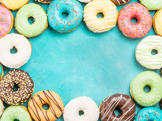 Wall Mural - donuts on blue background , copy space, top view