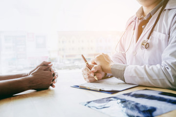 Wall Mural - Doctors and patients sit and talk. At the table near the window in the hospital.