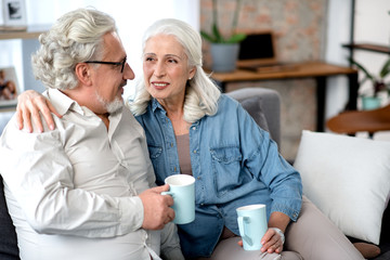 Wall Mural - Glad elderly married couple spending time together at home