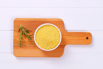 Wall Mural - bowl of raw millet grains