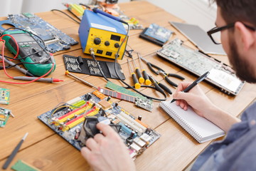 Poster - Electronic circuit board inspecting in repair shop