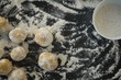 Overhead view of dough with flour in bowl