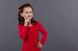 © olgasparrow - Portrait of a little girl in red dress on grey background emotions.
