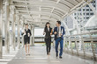 © Johnstocker - Business people walking to go meeting in office.