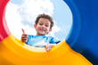 © weedezign - kid boy thumbs up and having fun to play on children's climbing toy at school playground,back to school activity,looking up view
