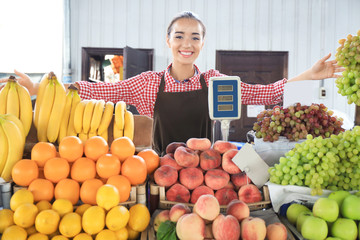 Wall Mural - Young seller in apron at market