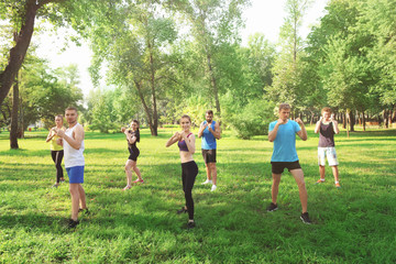 Wall Mural - Group of young people training in park