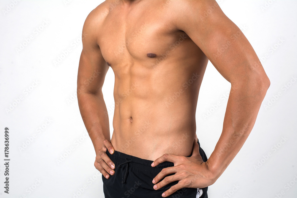 Muscular man showing six pack abs isolated on white background. - obrazy, fototapety, plakaty 