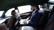 © ASDF - businessman using a laptop in the backseat of a car