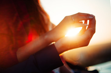 hands on sunset background, the sun in hand