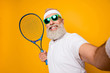 © deagreez - Competetive emotional cool grandpa with humor grimace exercising holding equipment, shoting photo. Body care, healthcare, weight loss, game, coach, champion, funky lifestyle