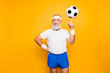 © deagreez - Bodycare, healthcare, weight loss, pride, strength, leadership, motivation, happiness, authority, gym concept. Cool funny modern competetive pensioner, leader, champion plays with ball