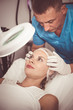 © JackF - Man doctor is analysing skin on face of female patient before the procedure