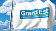 Waving flag with logo of Grand Est, a region of France. 3D rendering