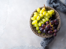 White And Dark Grapes In A Basket On Gray. Abstract Minimal Fruit Still Life