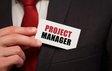Poster - businessman putting a card with text project manager in the pocket